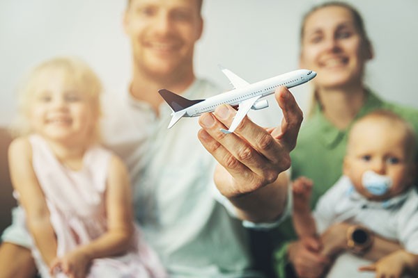 Family holding airplane